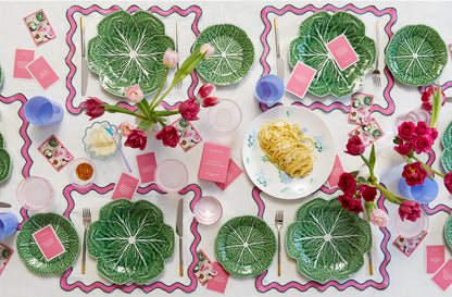 Pinka nd green tablescape setting with conversation cards peppered across the table.